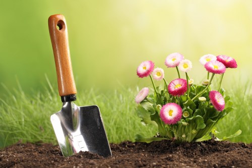 Professional gardener pruning plants in Westminster garden
